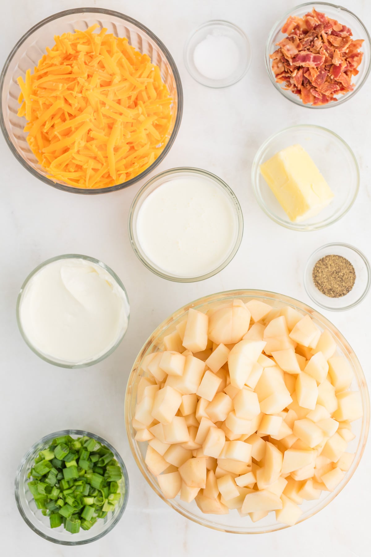 Ingredients for twice baked mashed potato casserole laid out on kitchen counter in prepration for the recipe.