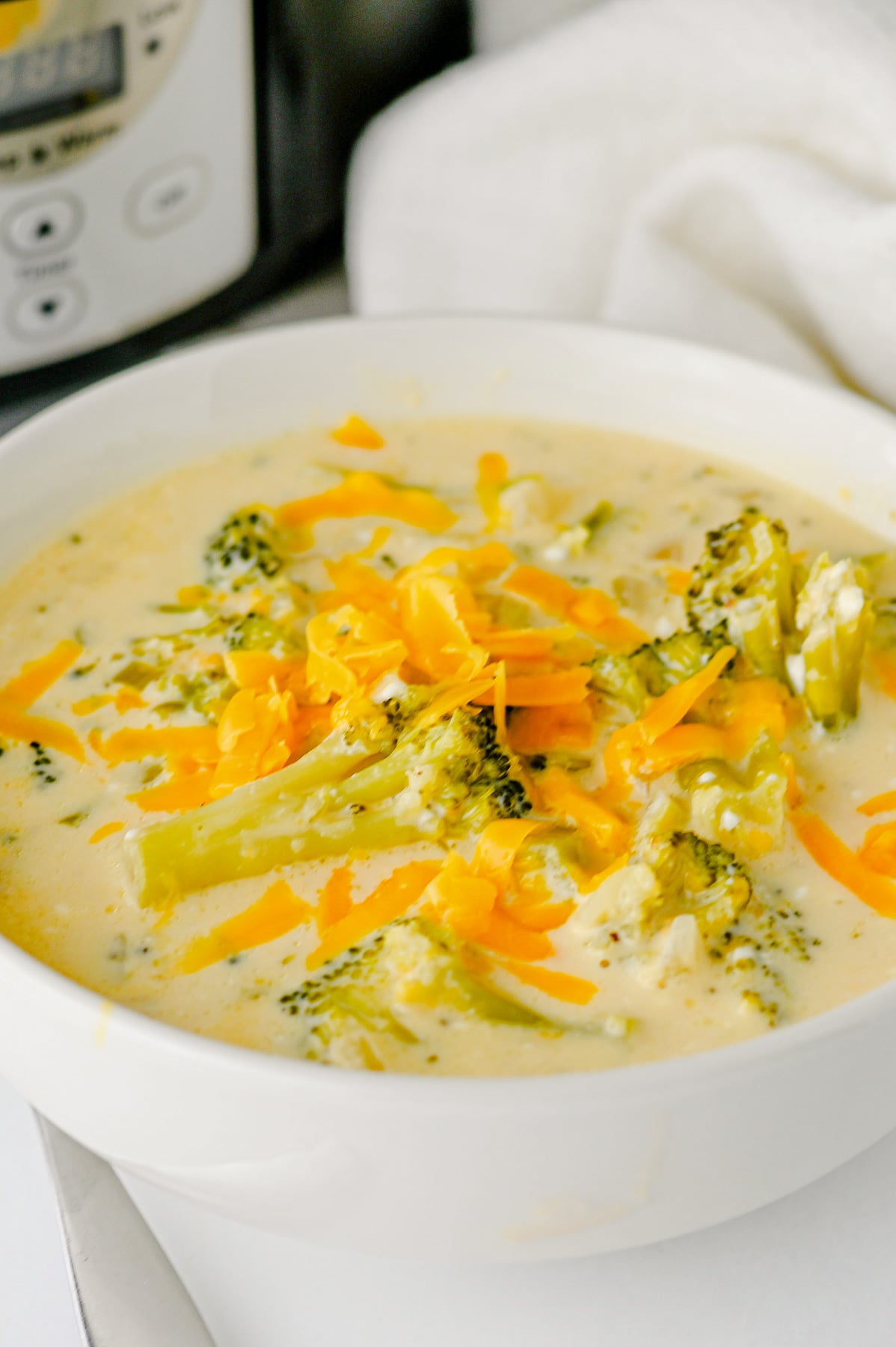Broccoli cheddar soup in a white bowl.