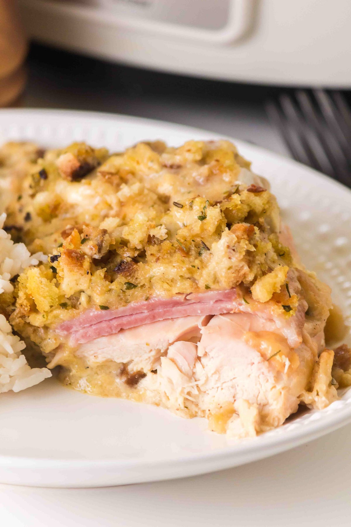 Crockpot chicken cordon bleu served on a white plate.