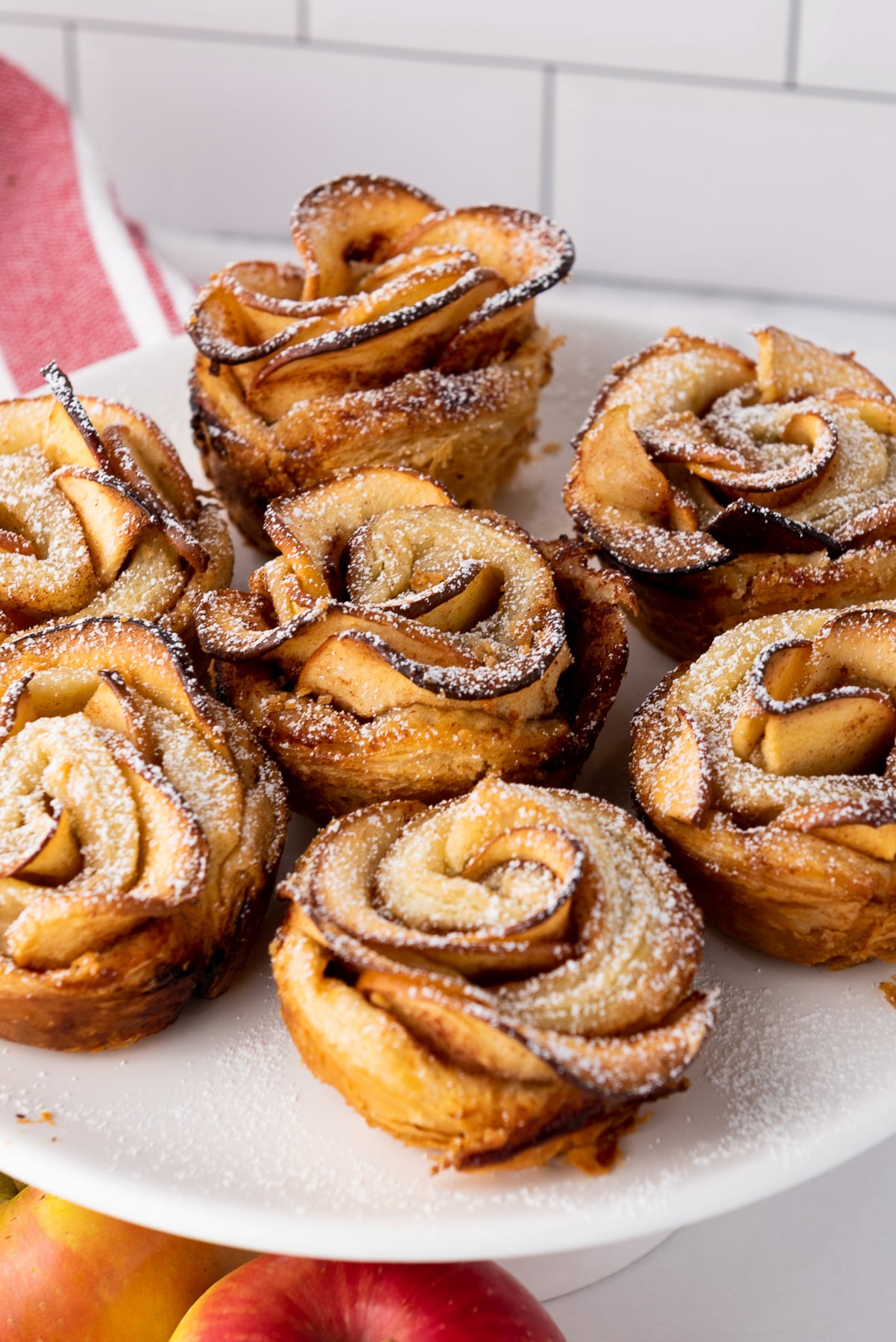 Puff pastry apple roses on a white plate.