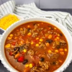 7 can taco soup in a white bowl.