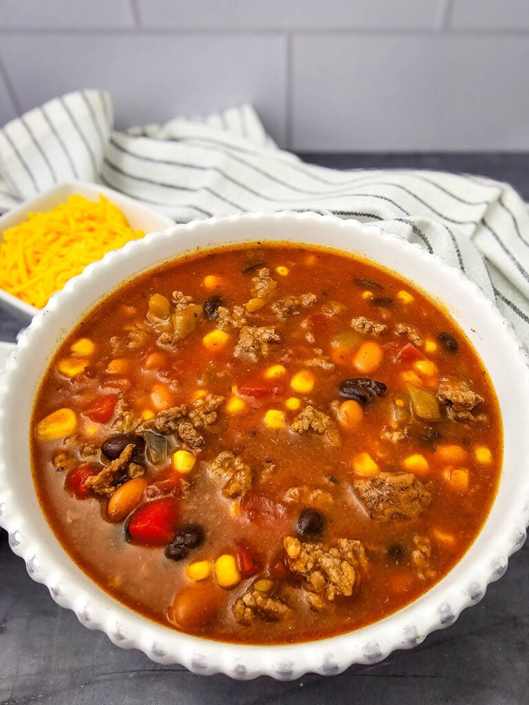 7 can taco soup in a white bowl.