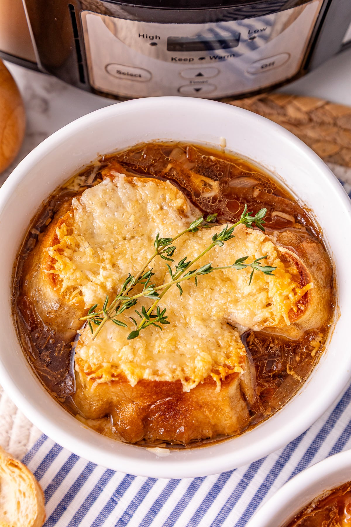 Crockpot French onion soup in soup bowl ready to eat.