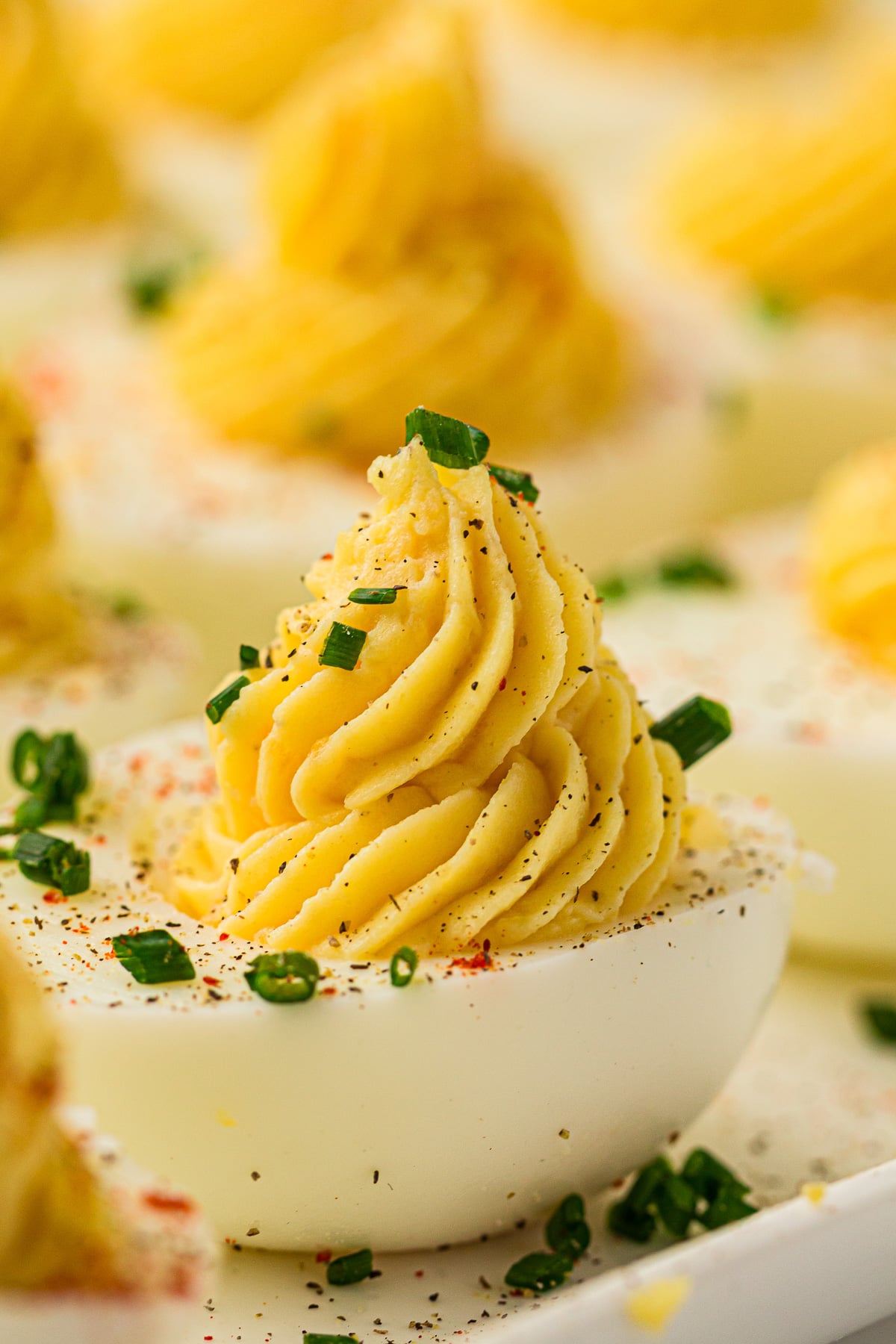 Devilled eggs served on a white plate.