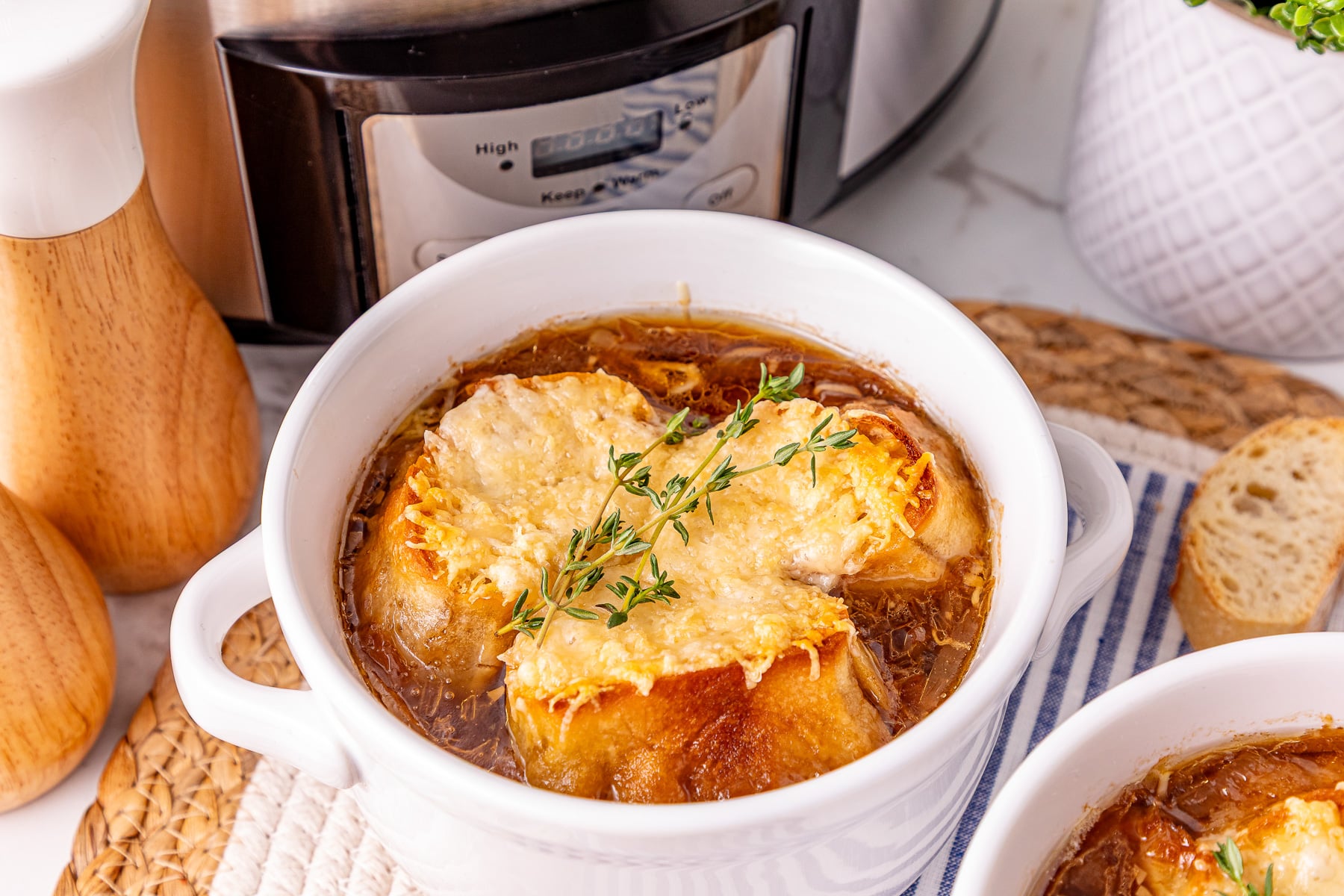 Finished dish of French onion soup in bowl ready to eat.
