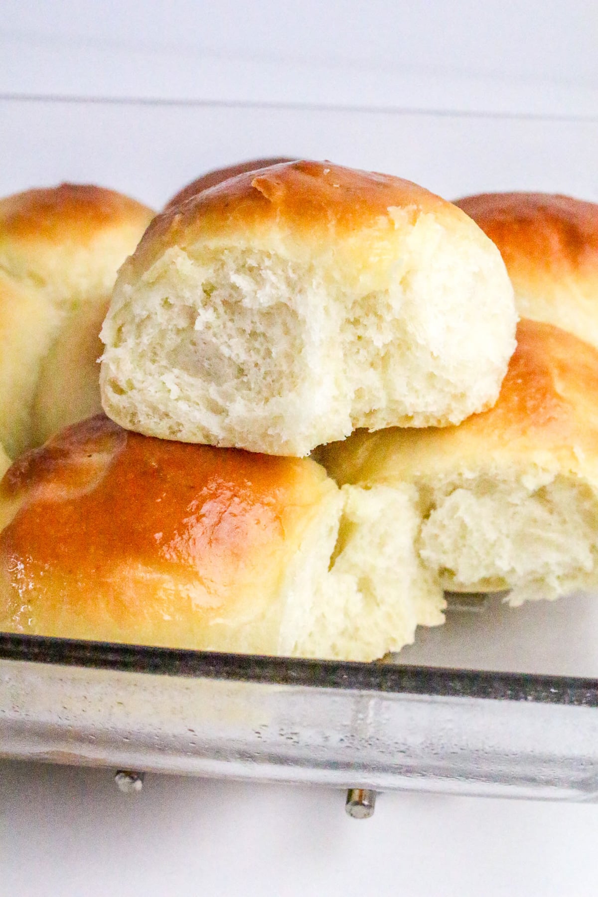Buttermilk dinner rolls stacked on serving tray.