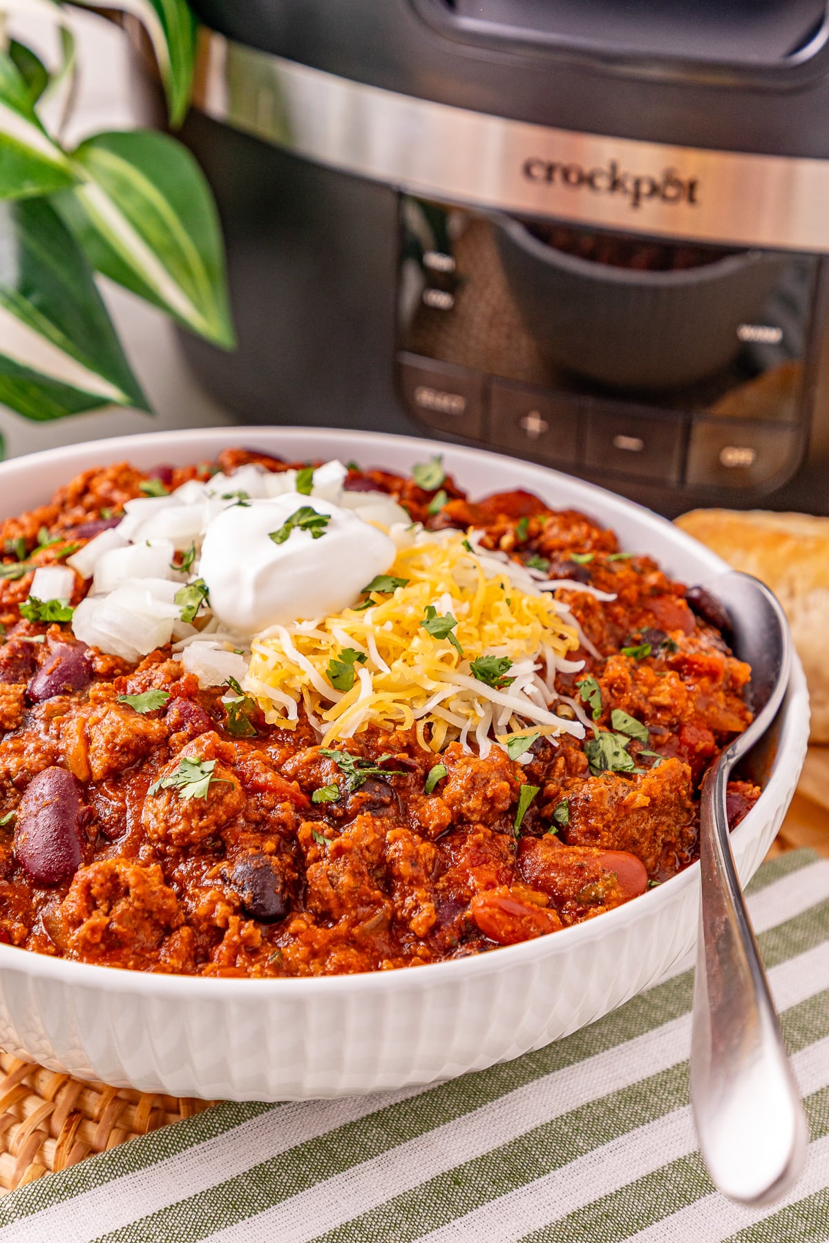 Crockpot ground beef chili in a white bowl.