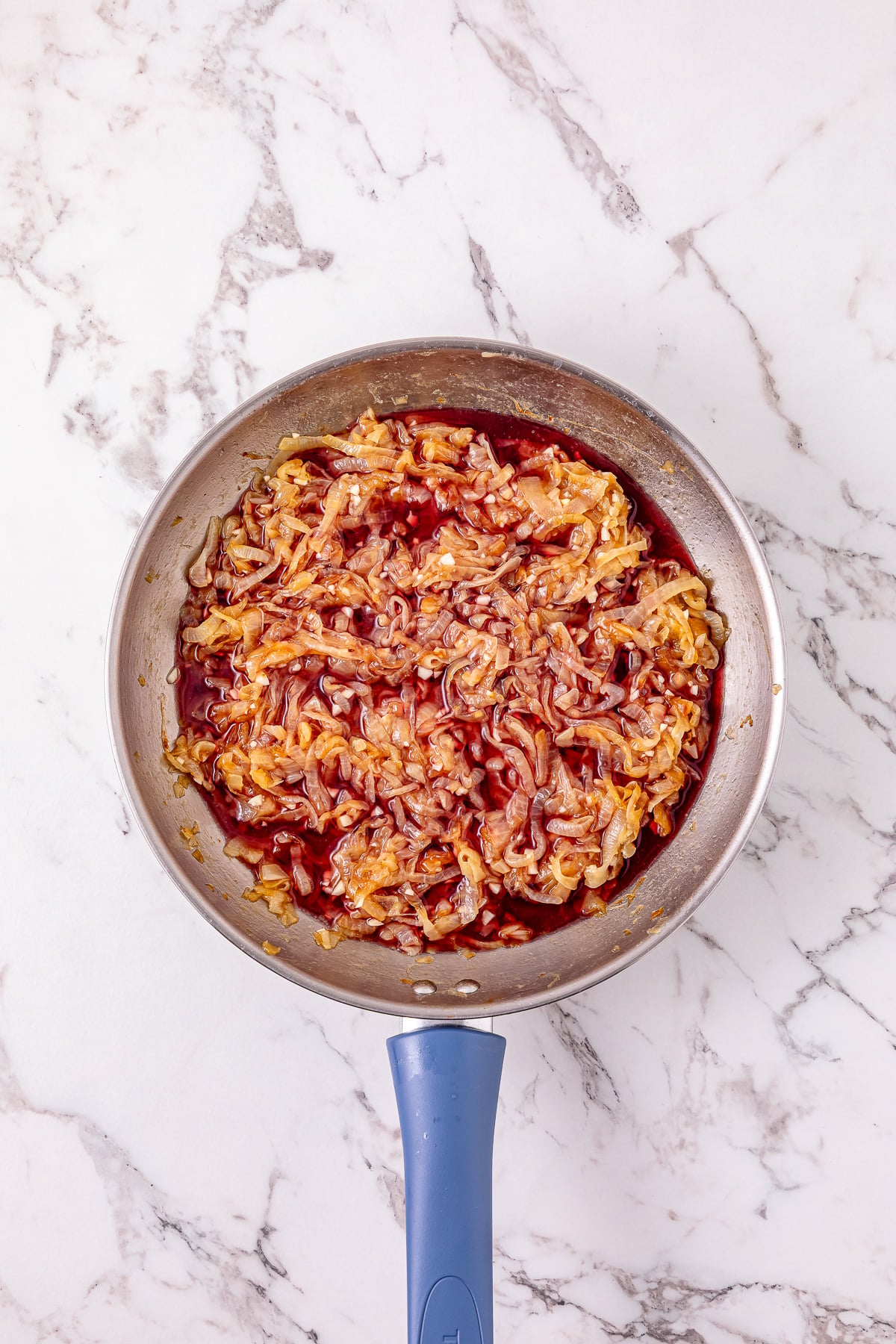 Red wine is added to the skillet.