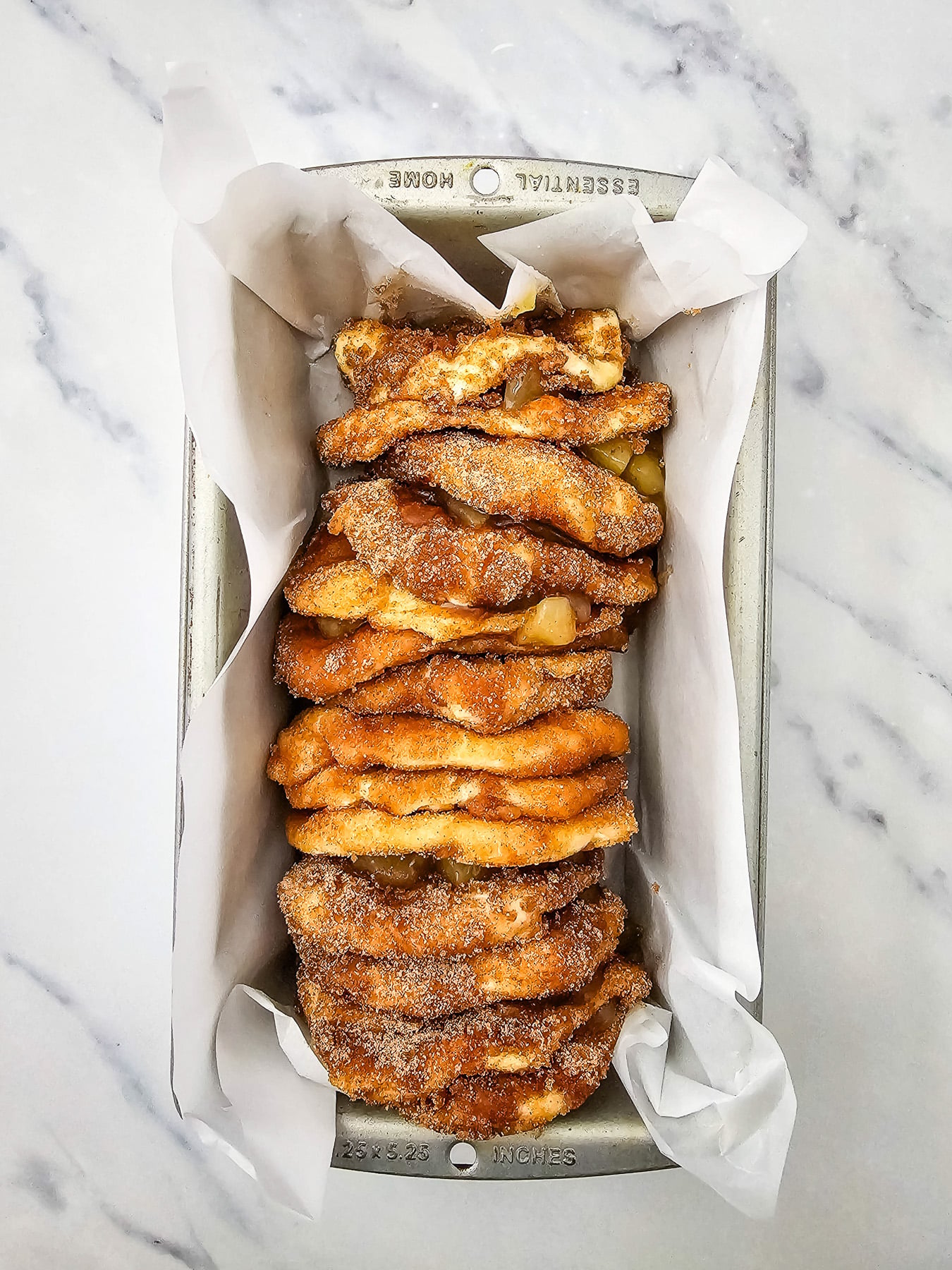 Biscuits are placed on their side and stacked in loaf pan.