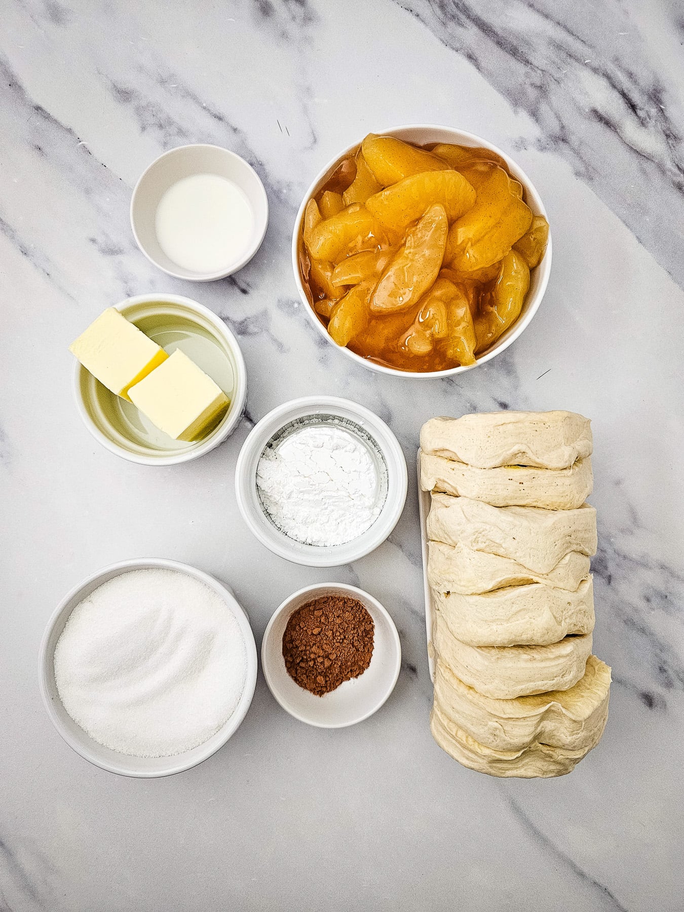 Ingredients for apple cinnamon biscuit loaf laid out on kitchen counter in preparation for making the fall dessert.