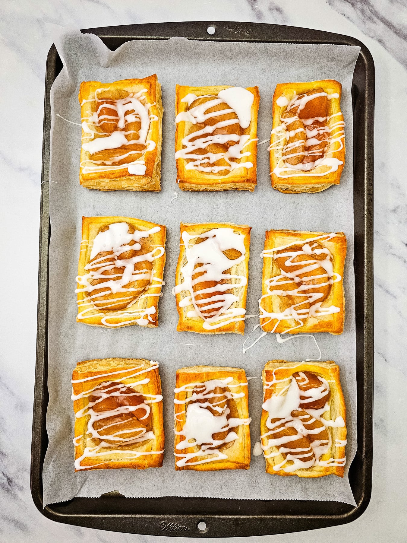icing is drizzled on finished pastries.