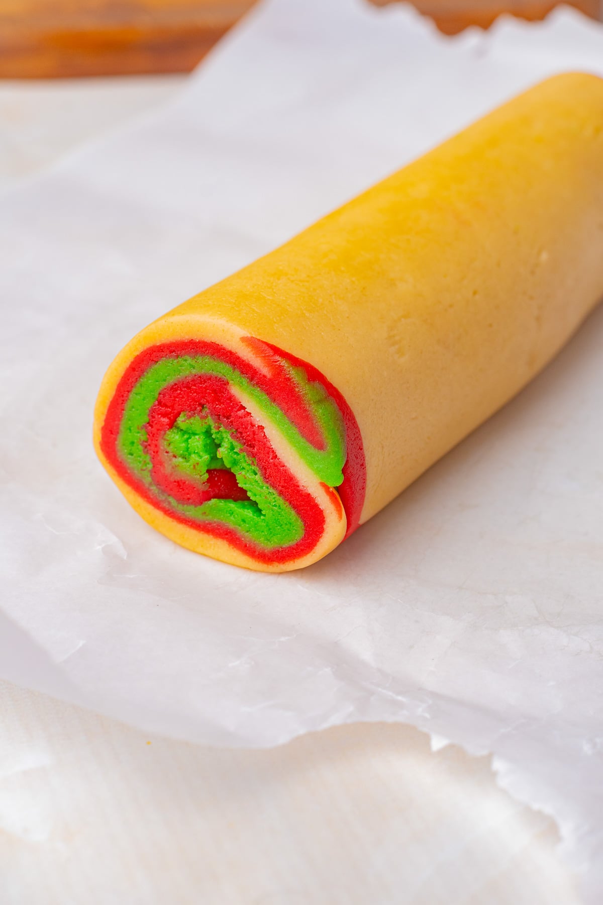 Cookie dough is rolled to shape a long.