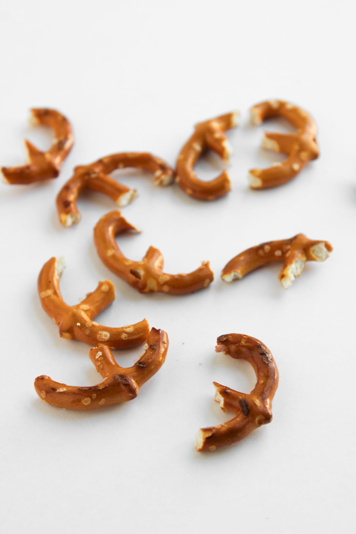 Broken pretzels on cutting board.