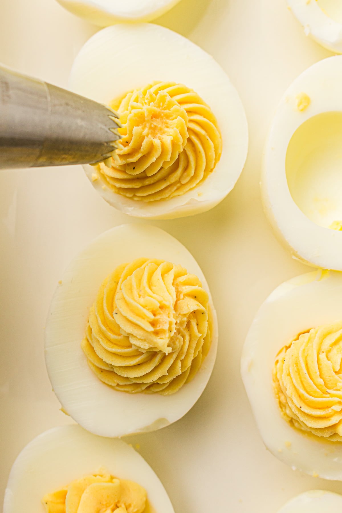 Yolk filling is piped into the hollowed out boiled egg half.