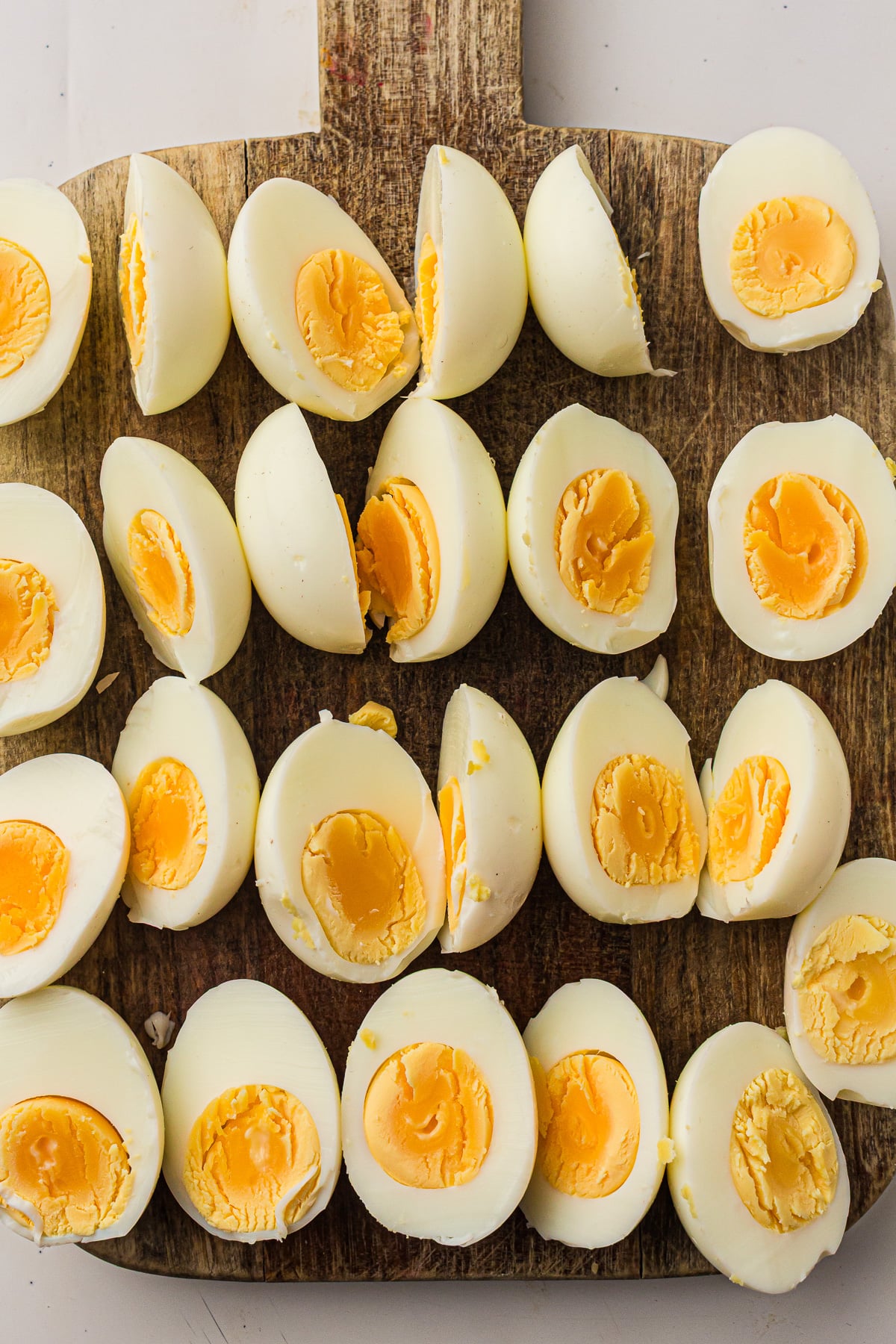 Sliced eggs on cutting board.
