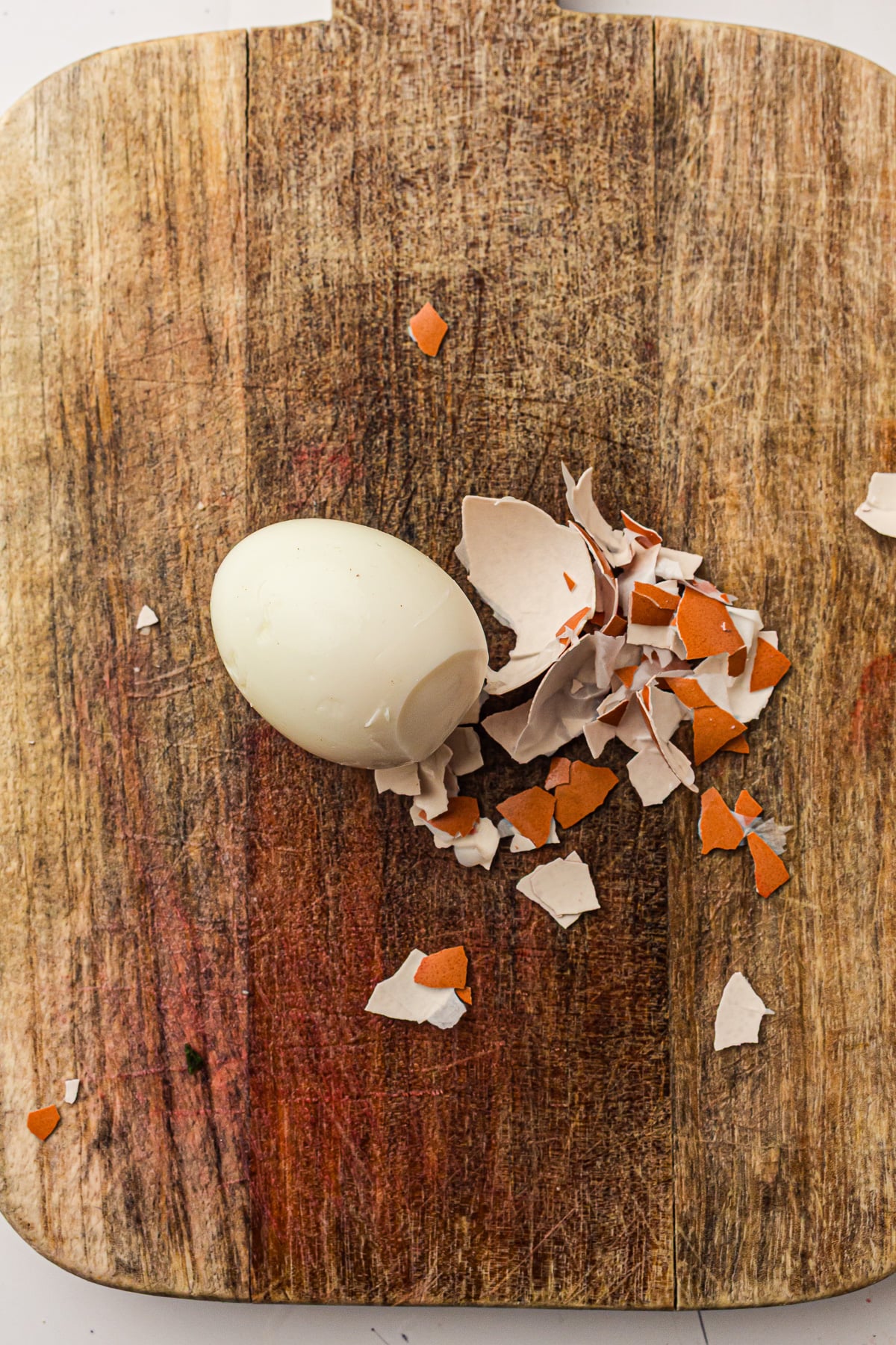 Peeled eggs on cutting board.