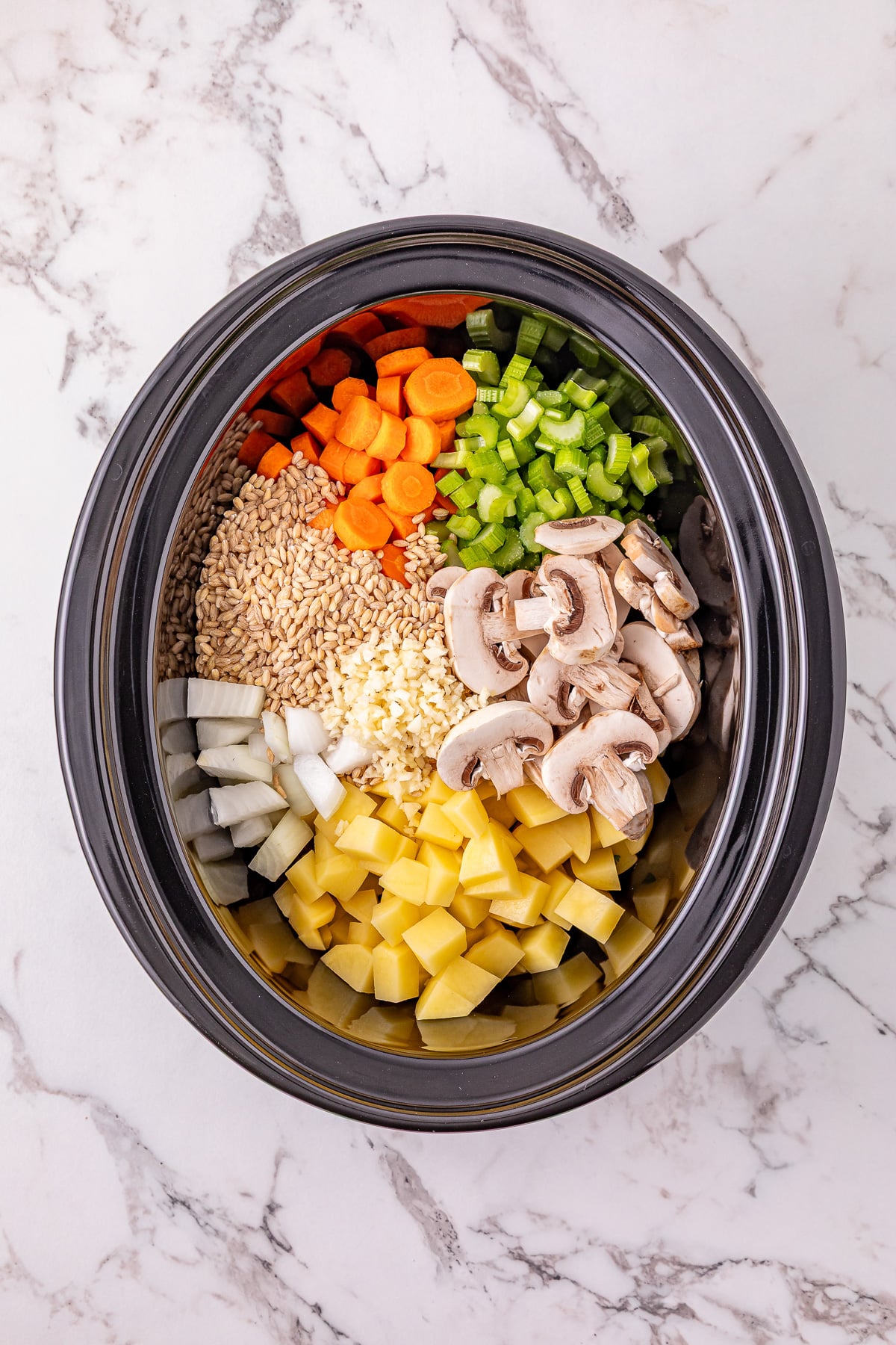 Next set of ingredients are added to the slow cooker.