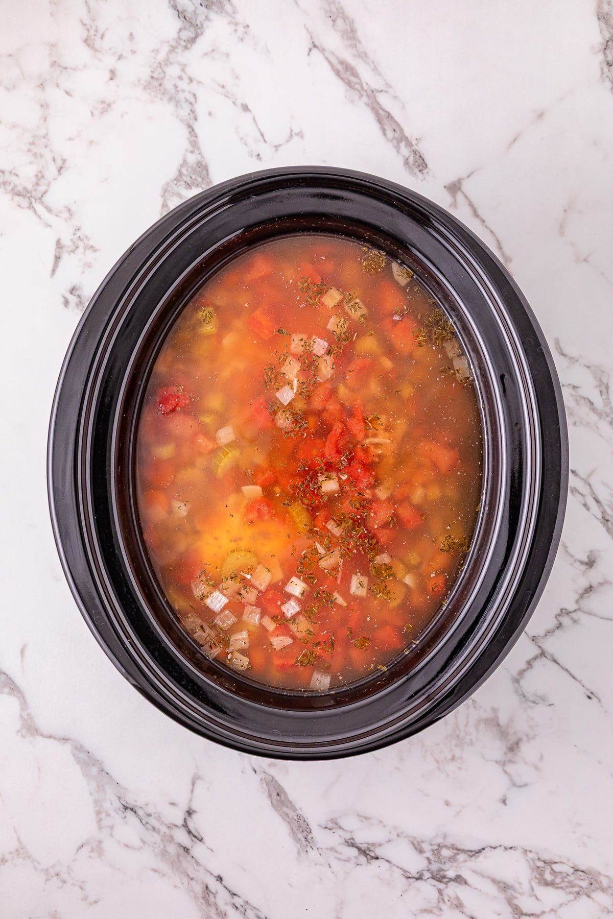 Broth is added to the crockpot.