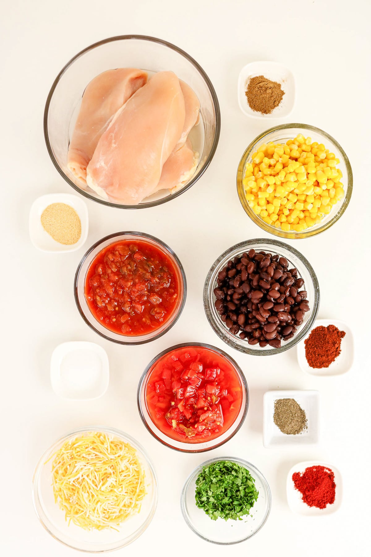 Ingredients for crockpot southweset chicken in small bowls on kitchen counter.