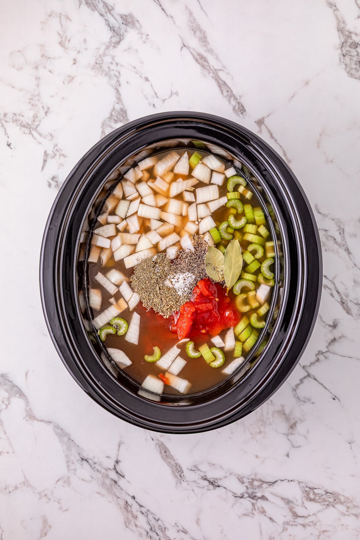 Seasonings are added to the crockpot.