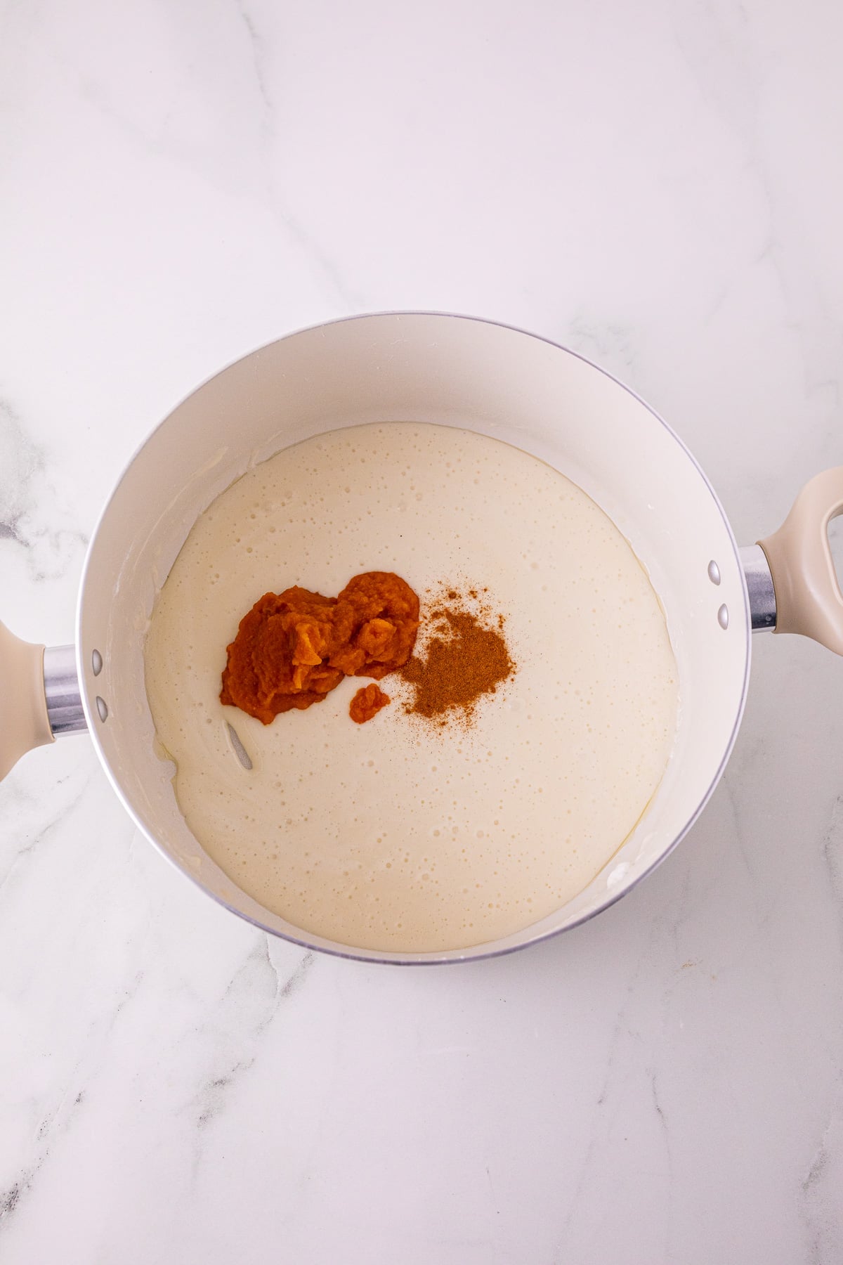 Melted butter and pumpkin puree in pot.