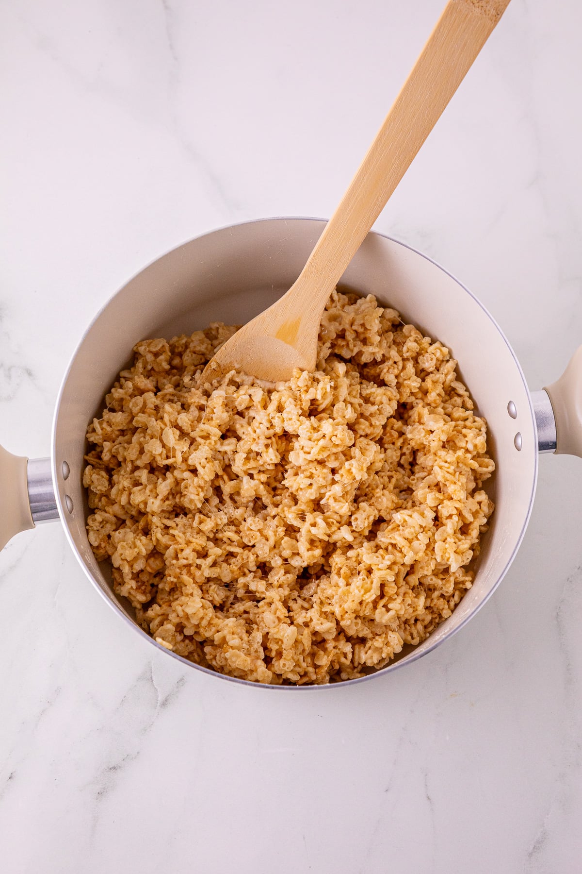 Rice Krispies are added to the butter and marshmallow mixture.