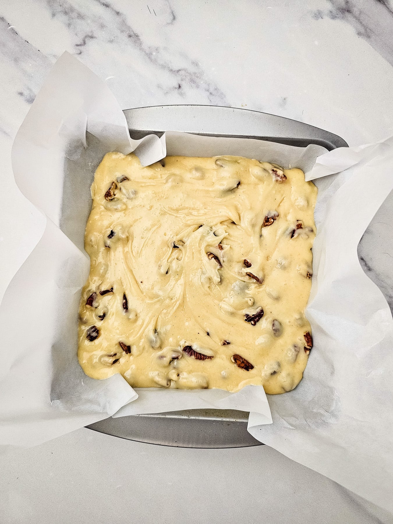 Mixture is poured into parchment lined baking sheet.