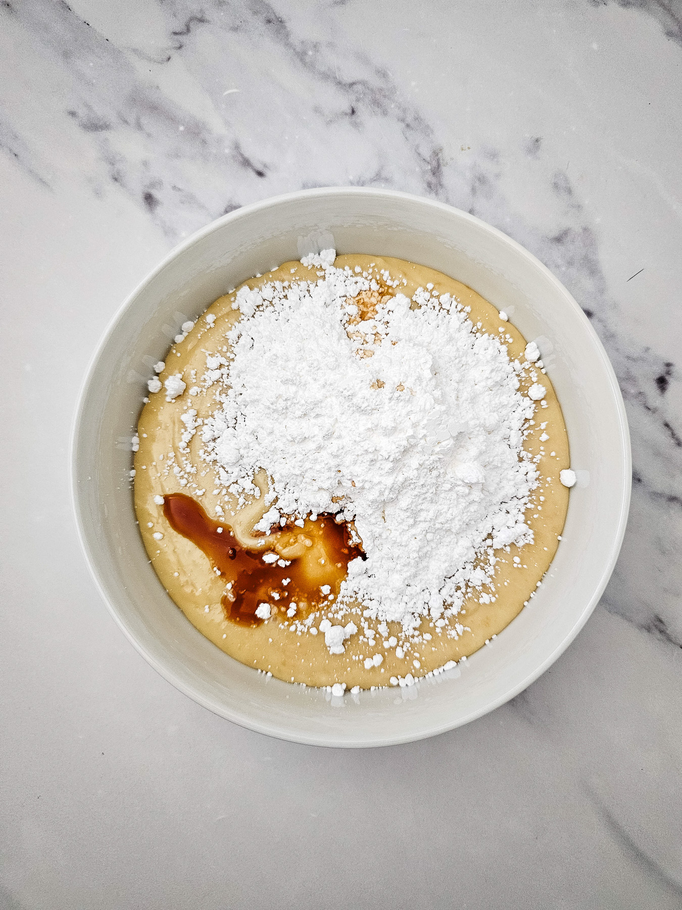 Powdered sugar is added to the bowl.