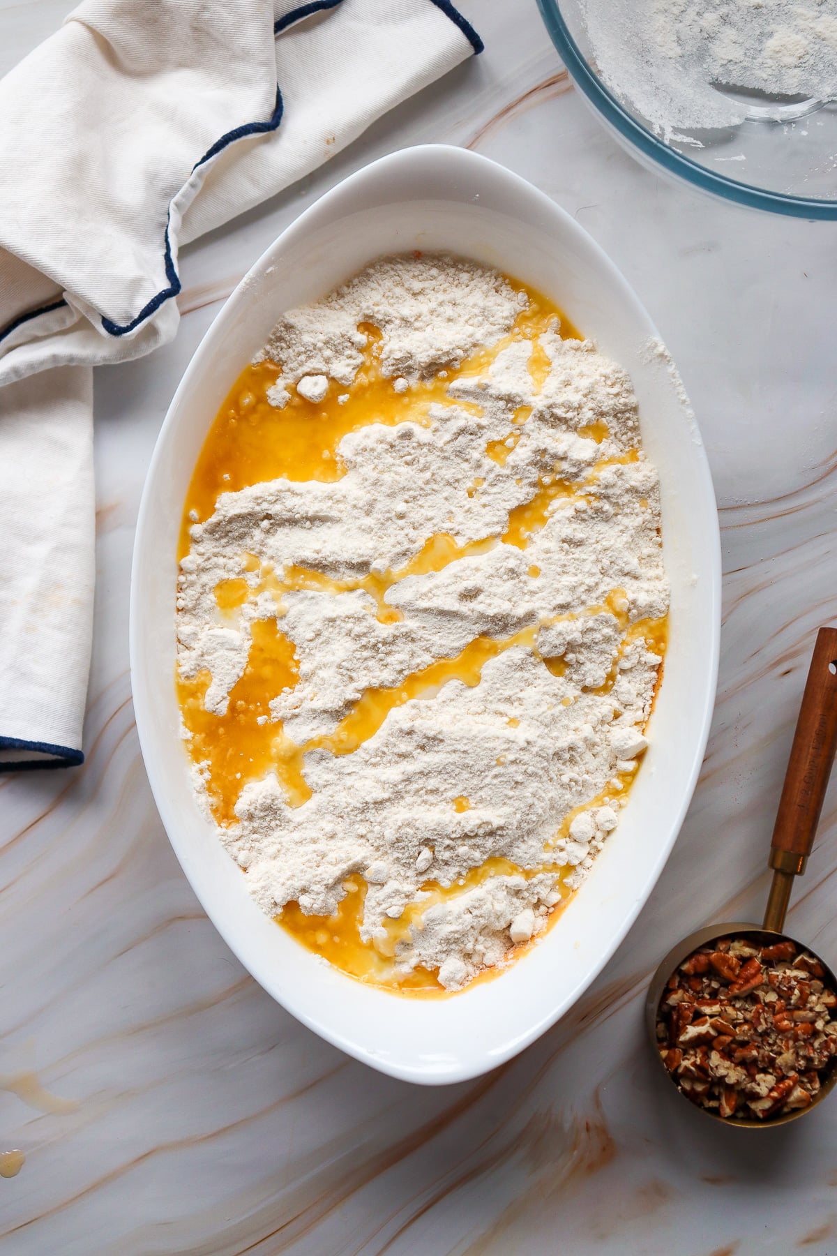 Melted butter is drizzled on top of spice cake mix.