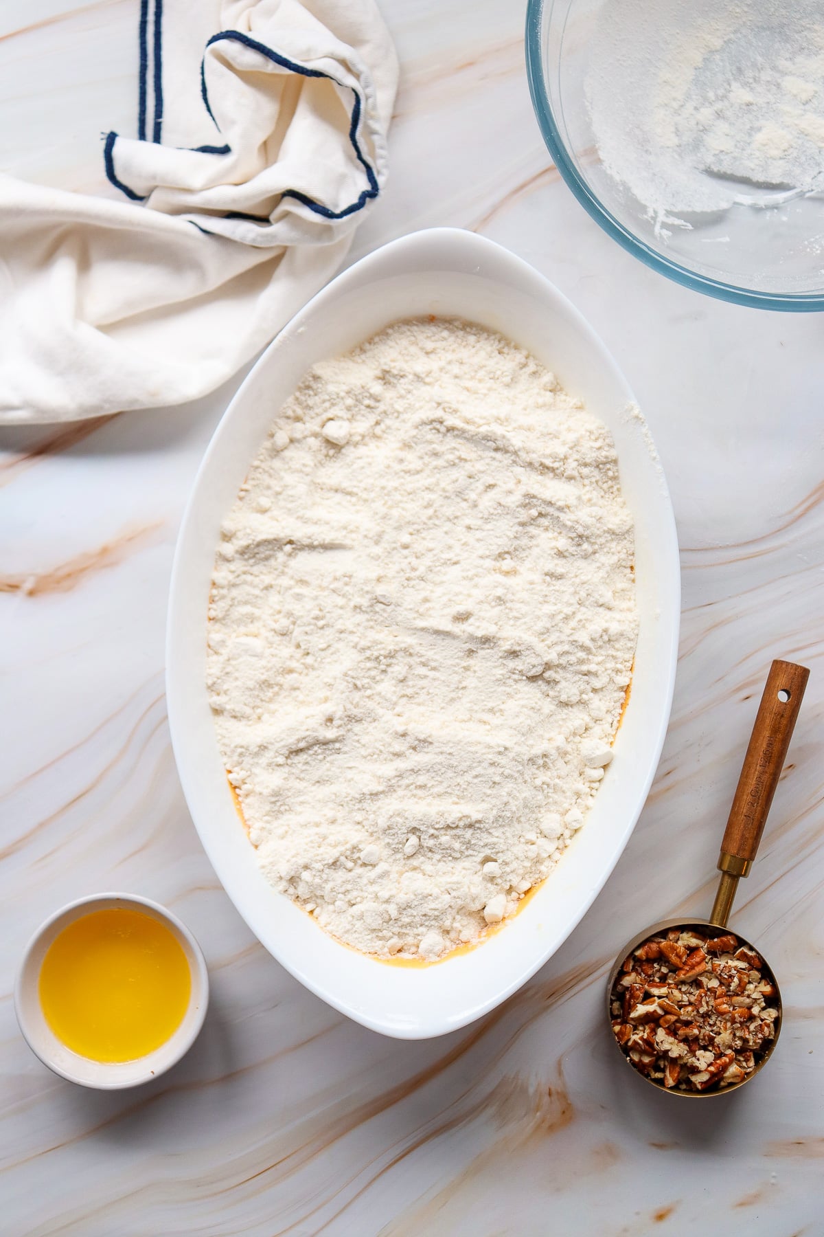 Cake mix is sprinkled on top of the dish.