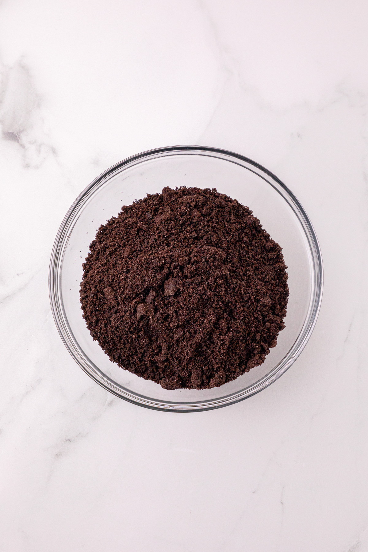 Oreo cookie crumbs in bottom of single-serve cups.