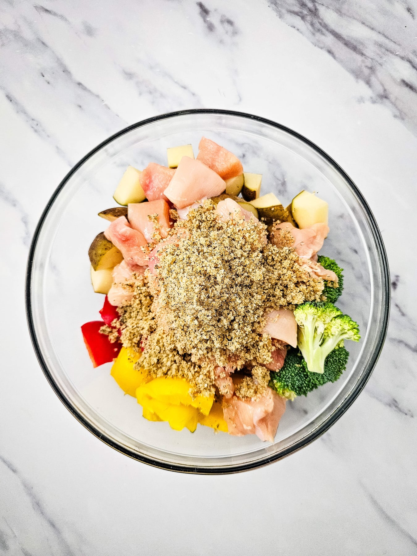 All ingredients are placed in glass bowl and mixed until coated with seasoning mixture.