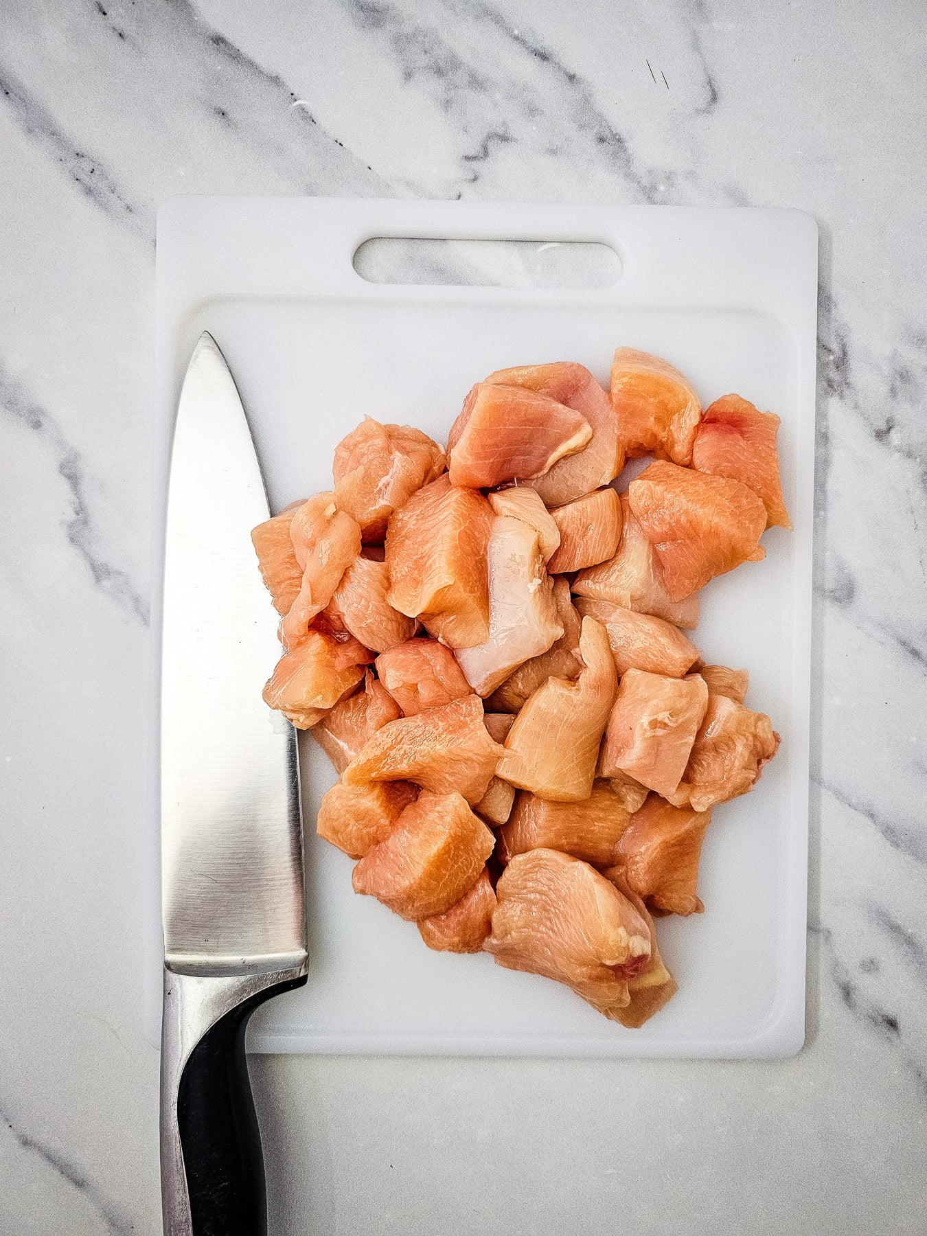 Chopped chicken on cutting board.