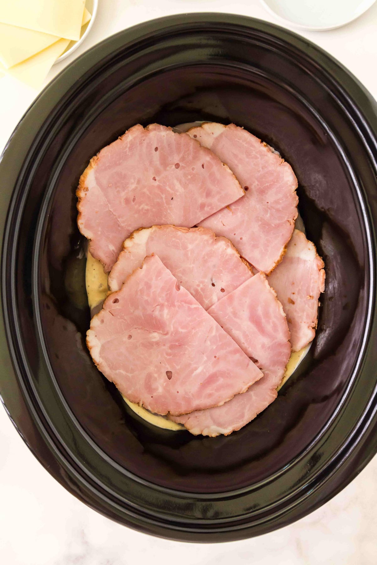 Layer of ham is place on top of the chicken.