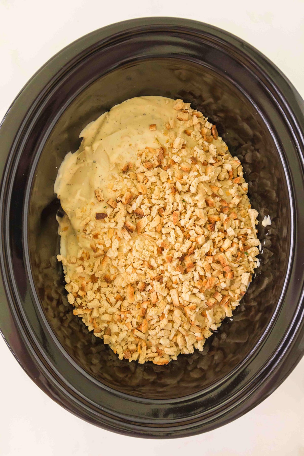 Stove Top stuffing mixture is spread on top the of the sauce for the final layer.