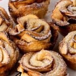 Puff pastry apple roses on a white plate.