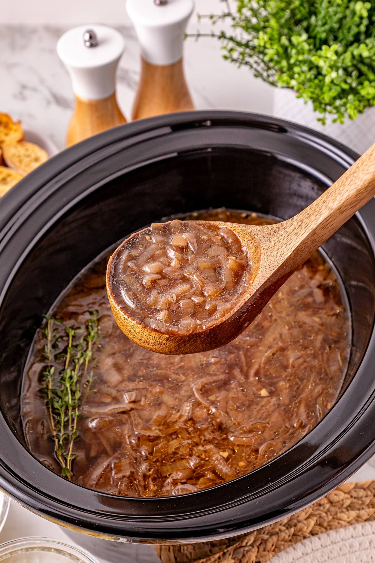 French onion soup in crockpot ready to serve into bowls.