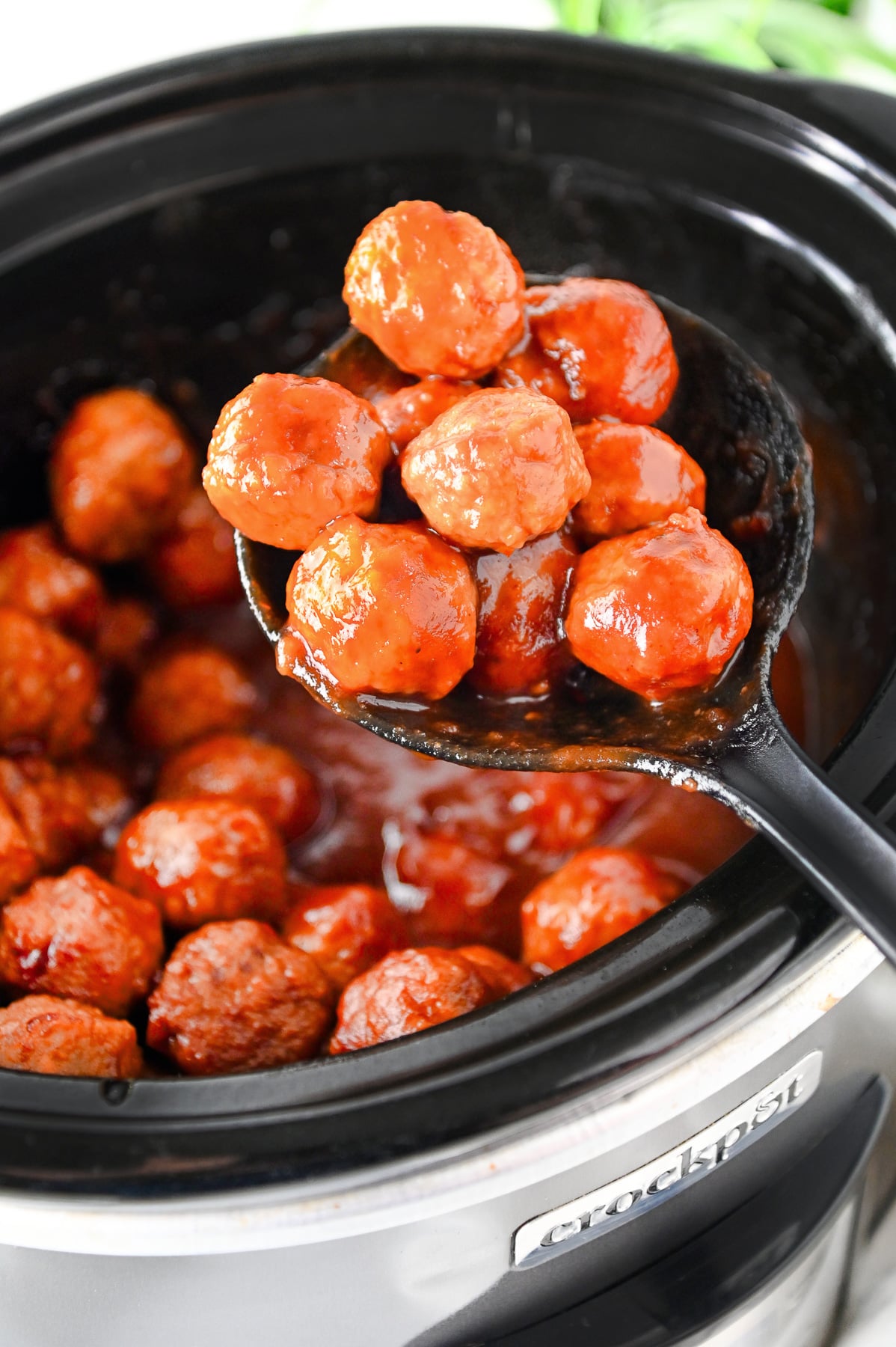 Finished dish of cranberry meatballs in slow cooker.