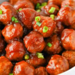 Cranberry meatballs in a white bowl.