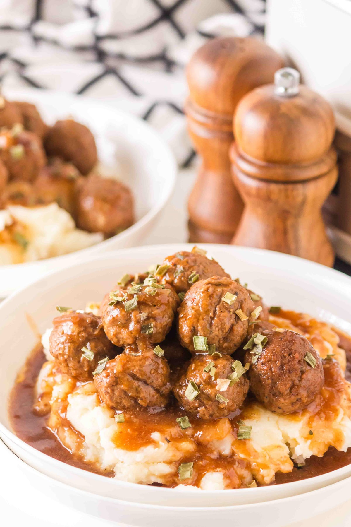 Slow cooker salisbury meatballs with mashed potatoes and gravy in a dinner bowl.
