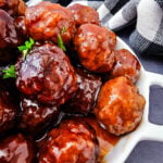 Grape jelly bbq meatballs in white bowl ready to be served.