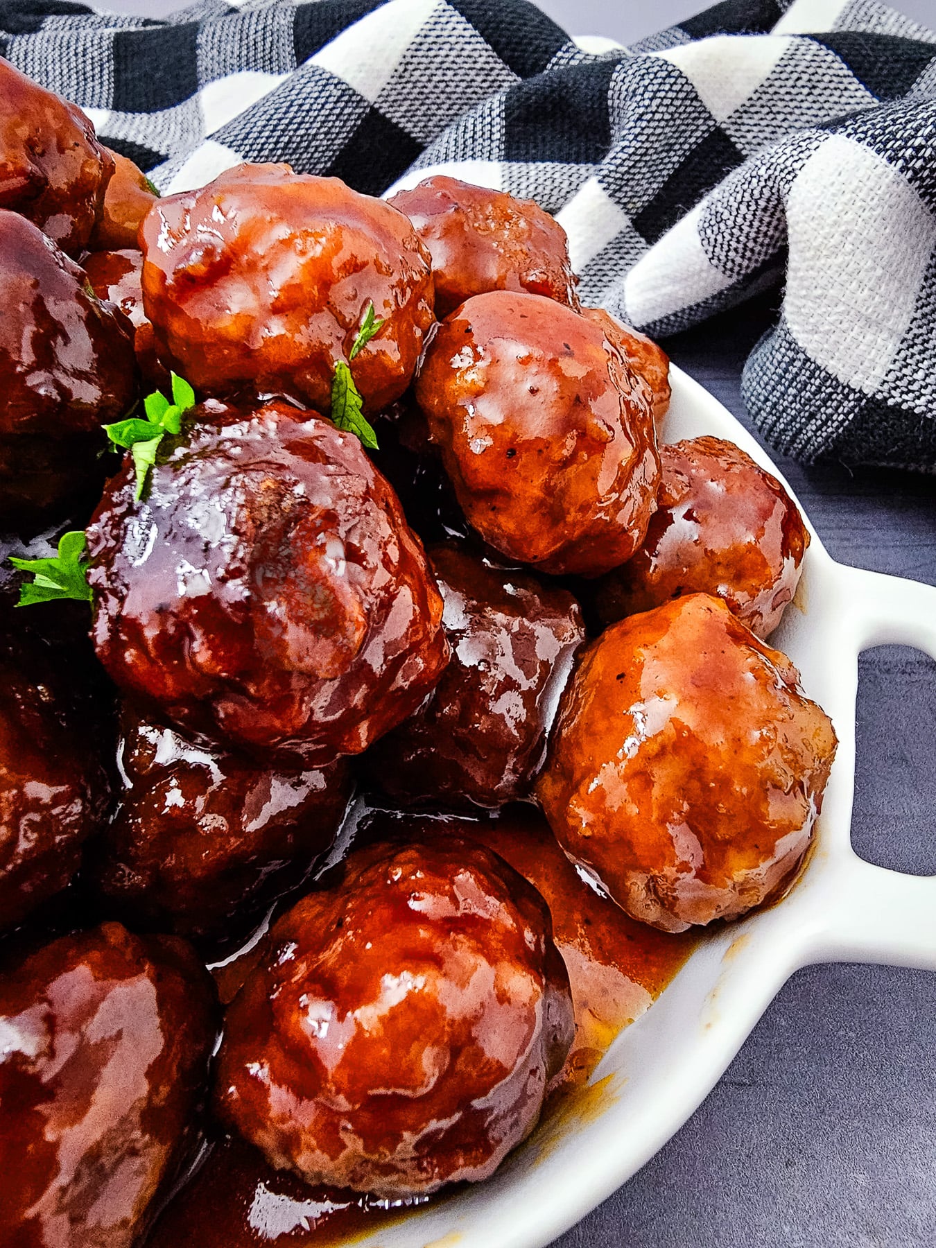 Grape jelly bbq meatballs in white bowl ready to be served.