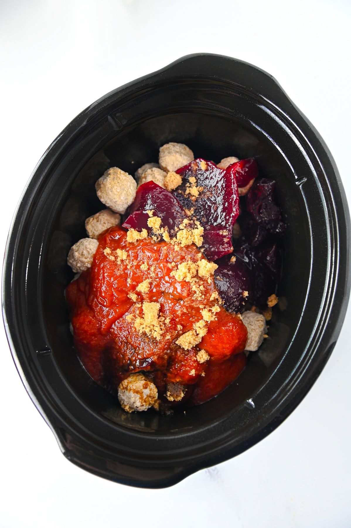 All ingredients for cranberry meatballs in slow cooker.