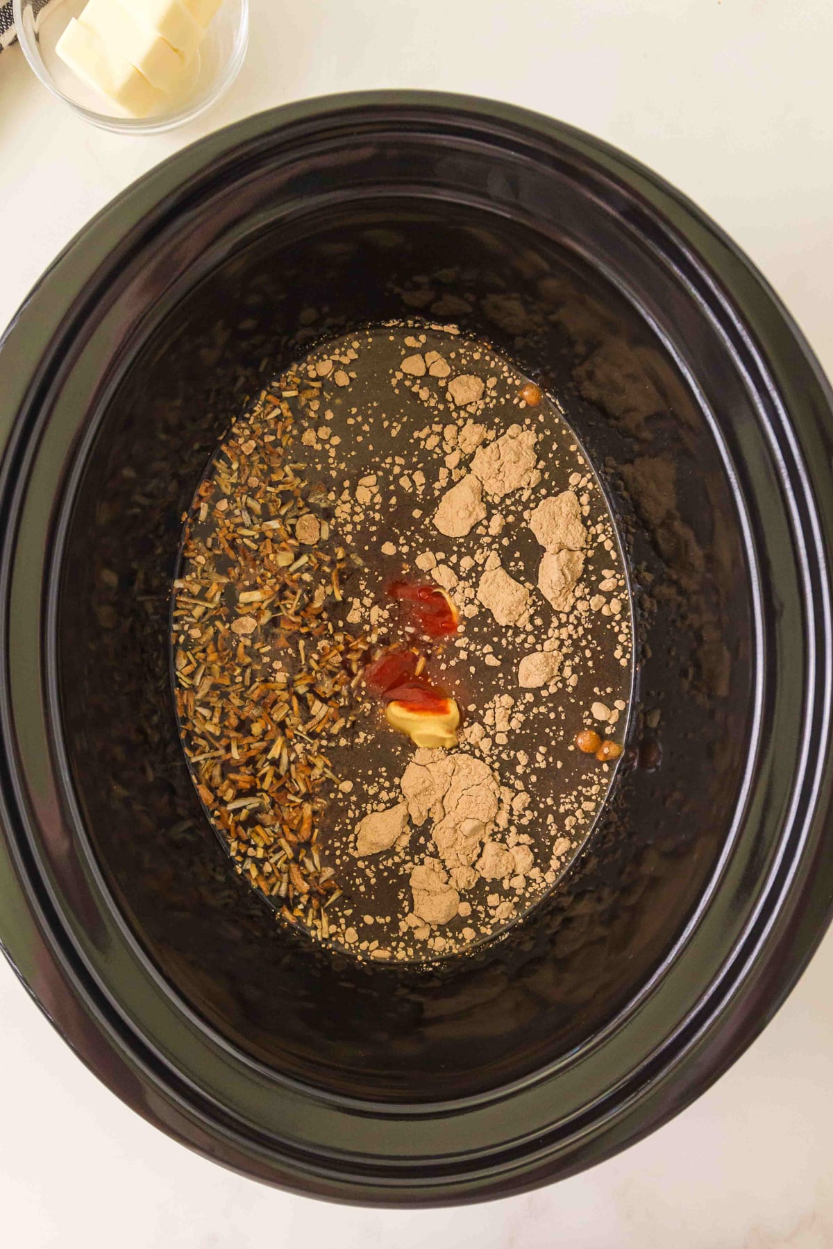 First set of ingredients are added to the bottom of the slow cooker.