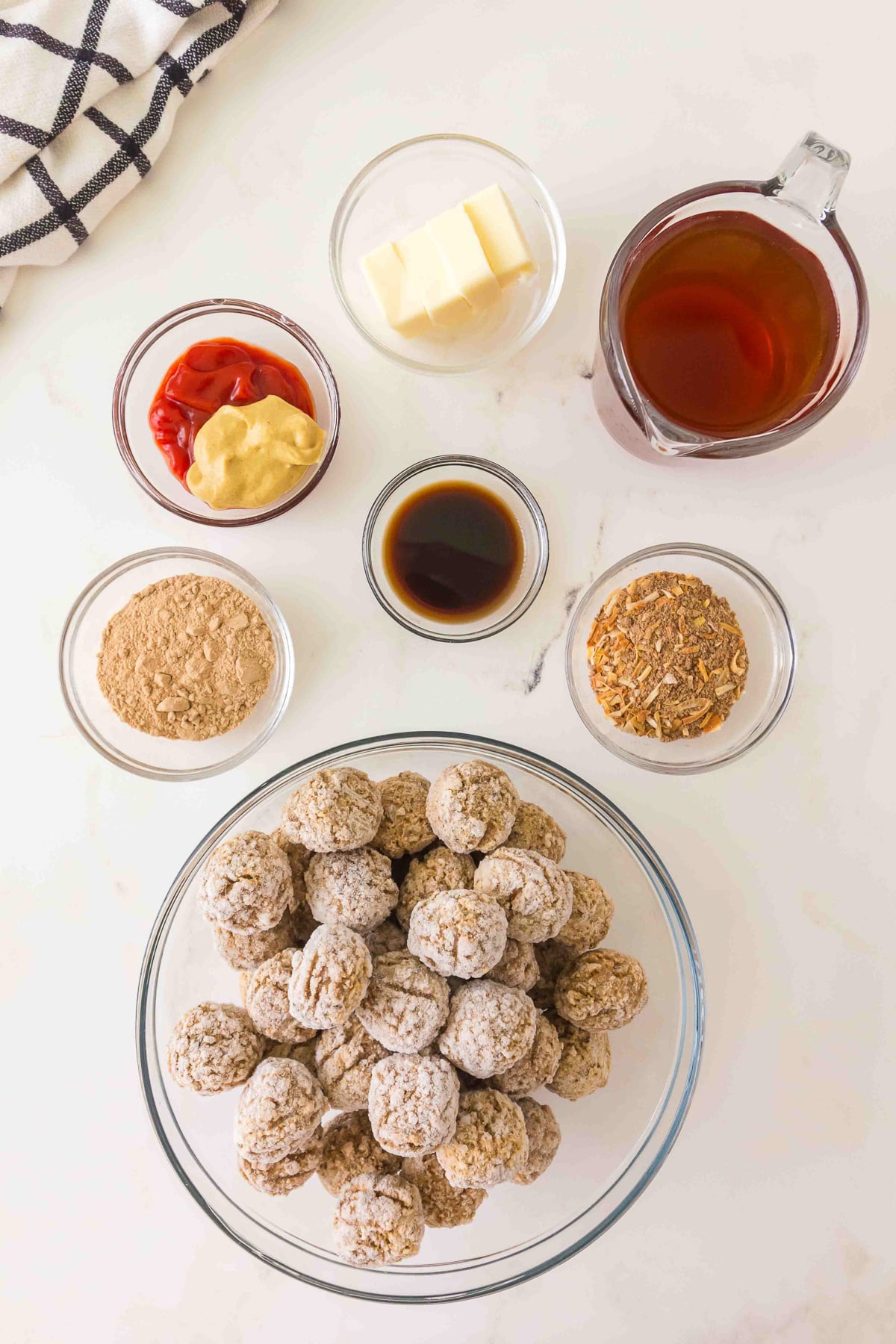 Crockpot salisbury meatballs ingredients laid out on kitchen counter in small bowls.