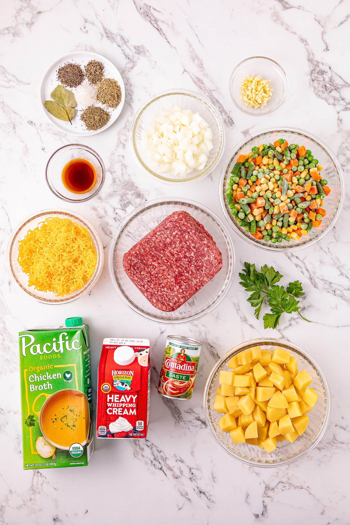 Ingredients for soup laid out in small bowls on kitchen counter.
