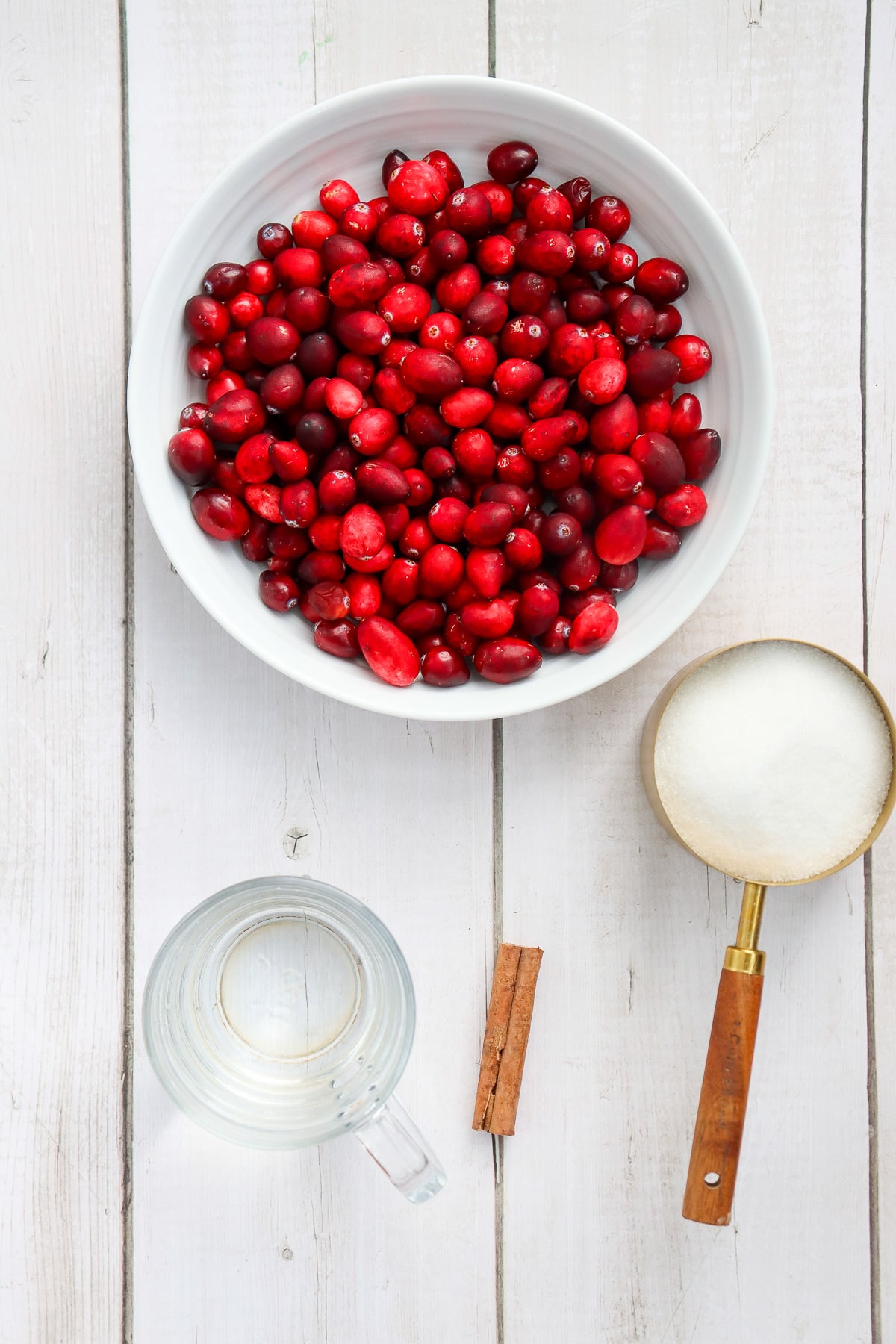 Ingredients for cranberry sauce laid out on kitchen counter in preparation for the recipe.