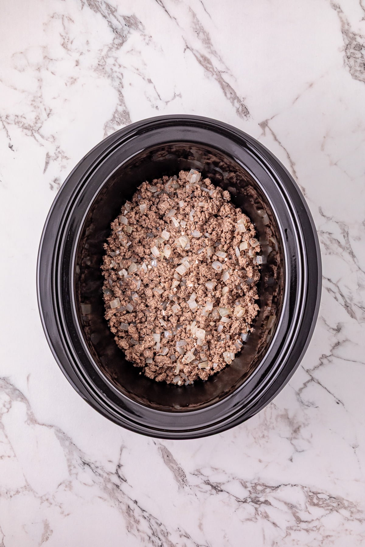 Cooked ground beef in crockpot.