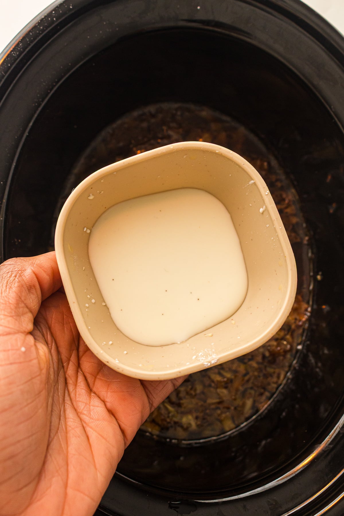 Cornstarch mixture is added to the slow cooker.
